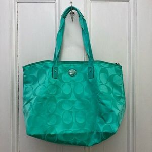 Green Coach overnight bag with matching snap in toiletry bag